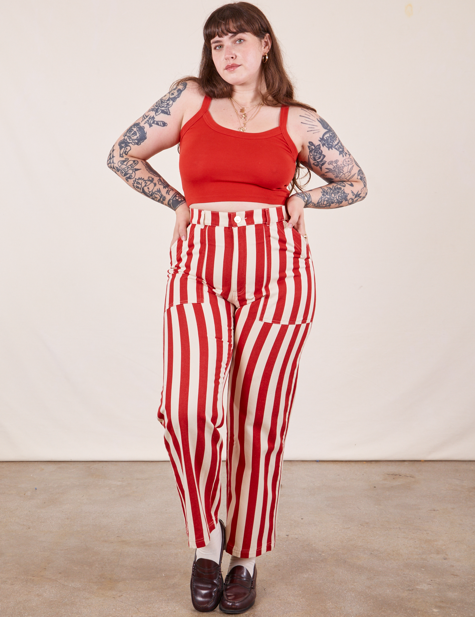 Sydney is 5&#39;9&quot; and wearing L Work Pants in Cherry Stripe paired with mustang red Cropped Cami