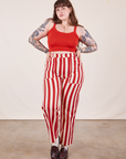 Sydney is 5'9" and wearing L Work Pants in Cherry Stripe paired with mustang red Cropped Cami