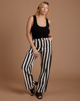 Tiara is wearing Black Stripe Work Pants in White and black Cropped Tank