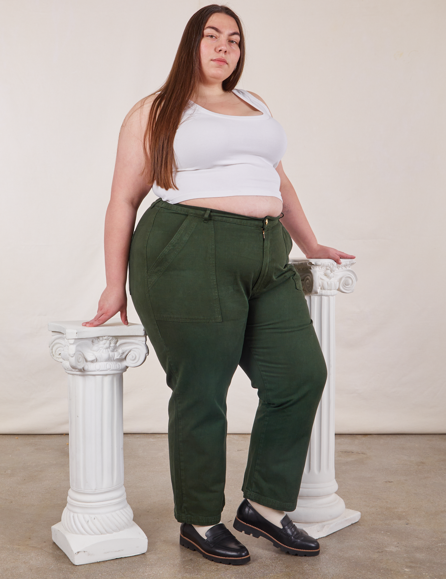Angled front view of Work Pants in Swamp Green and vintage tee off-white Cropped Tank on Marielena