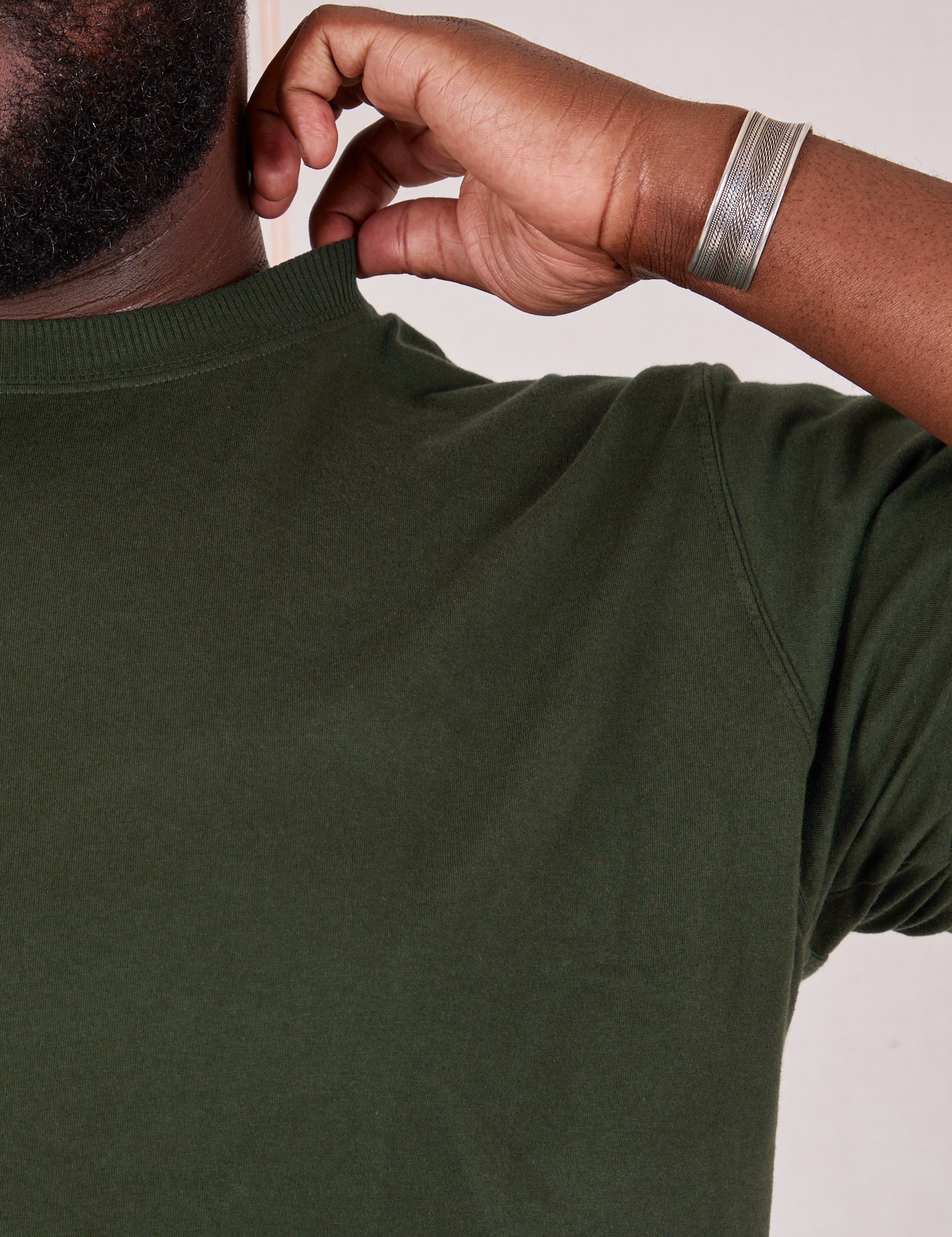 Organic Vintage Tee in Swamp Green shoulder close up on Elijah