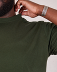 Organic Vintage Tee in Swamp Green shoulder close up on Elijah