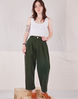 Hana is 5'3" and wearing XXS Petite Heavyweight Trousers in Swamp Green paired with Cropped Tank Top in vintage tee off-white