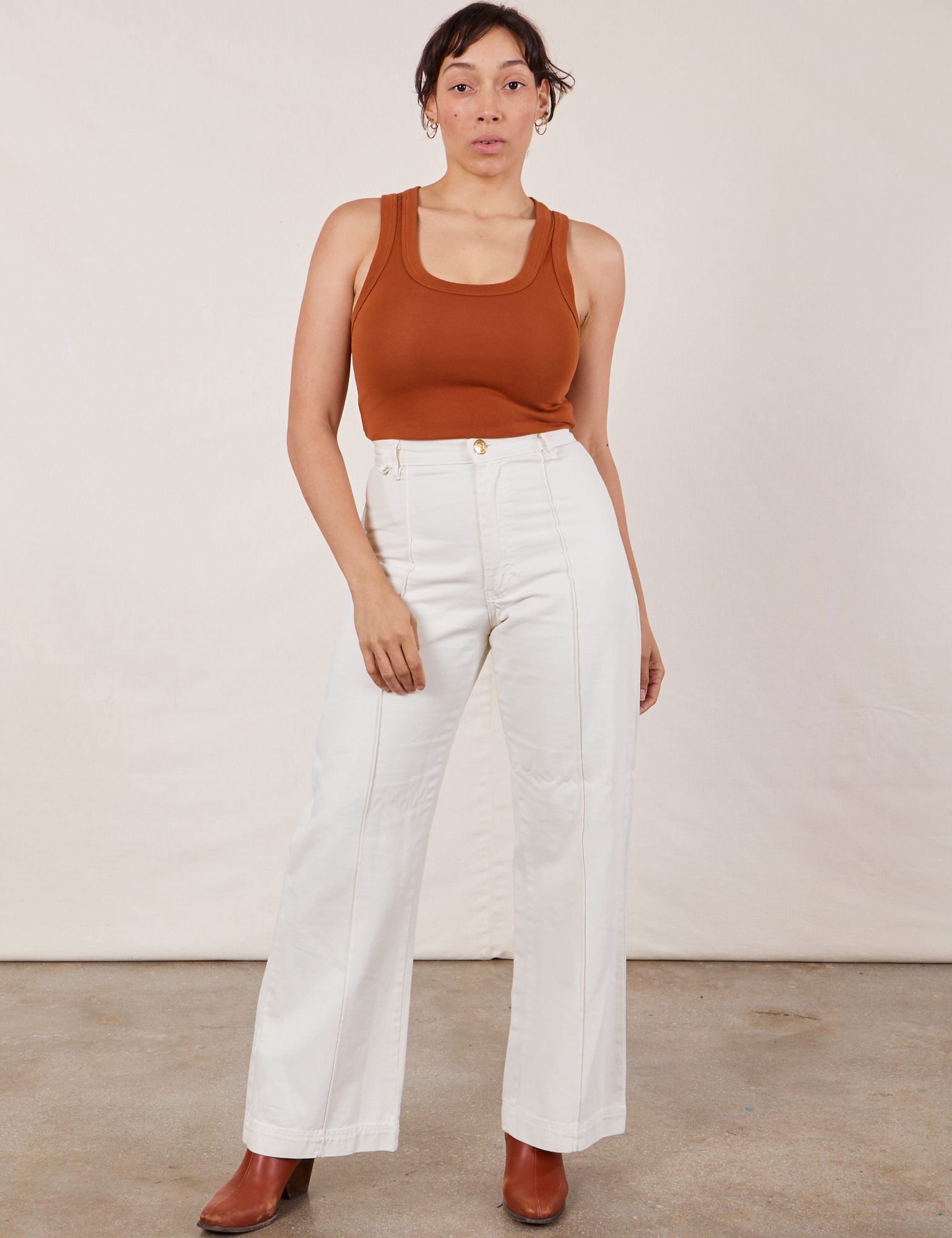 Tiara is wearing Tank Top in Burnt Terracotta tucked into vintage tee off-white Western Pants