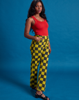 Angled front view of Checkerboard Work Pants in Yellow/Black and mustang red Tank Top on Kandia