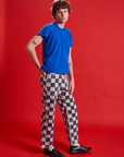 Side view of Checkerboard Work Pants in Black/White and royal blue Organic Vintage Tee on Quinn