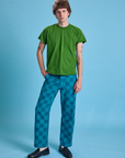 Quinn is 6'3" and wearing M Checkerboard Work Pants in Blues paired with lawn green Organic Vintage Tee