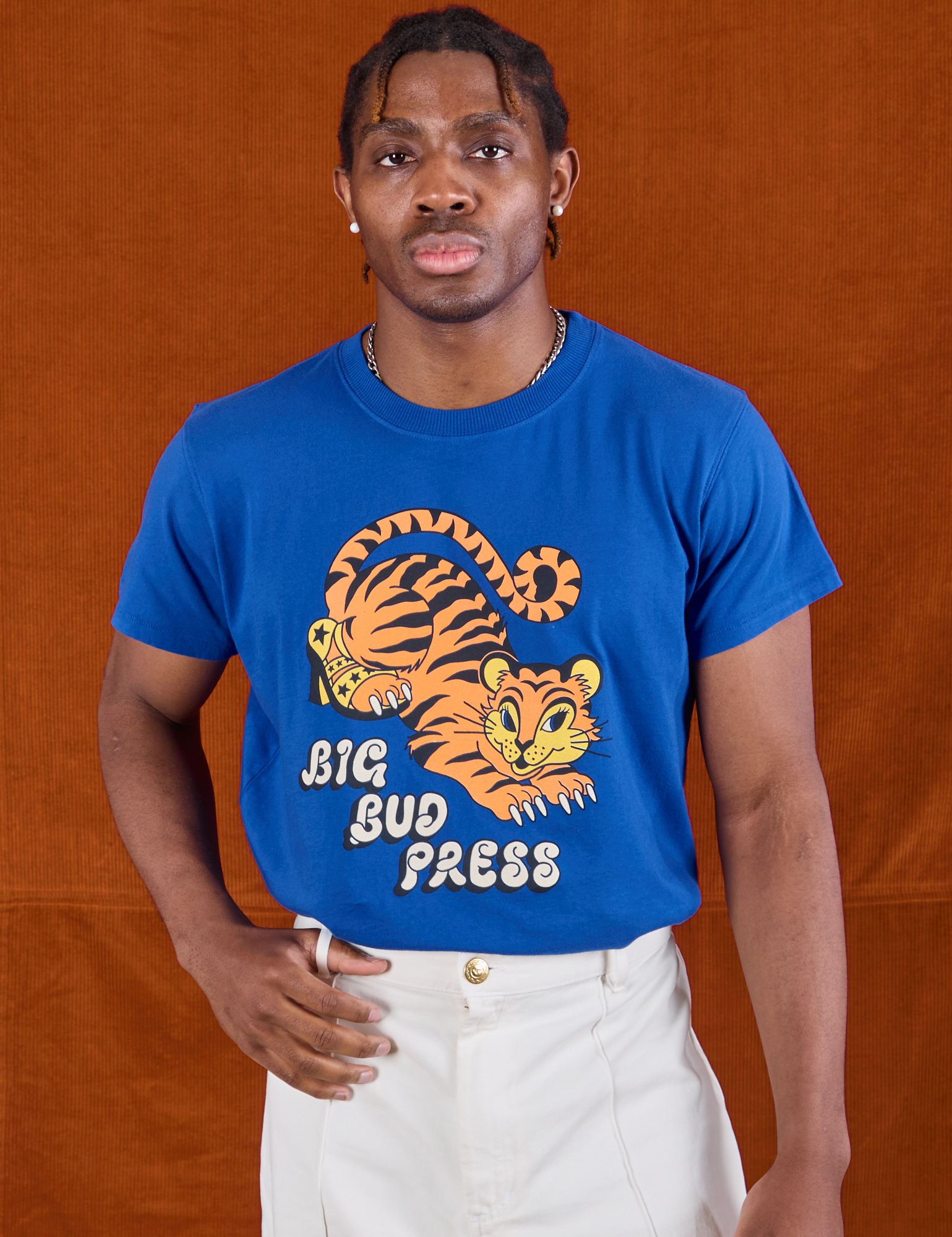 Isaac is wearing BBP Tiger Tee tucked into vintage tee off-white Western Pants
