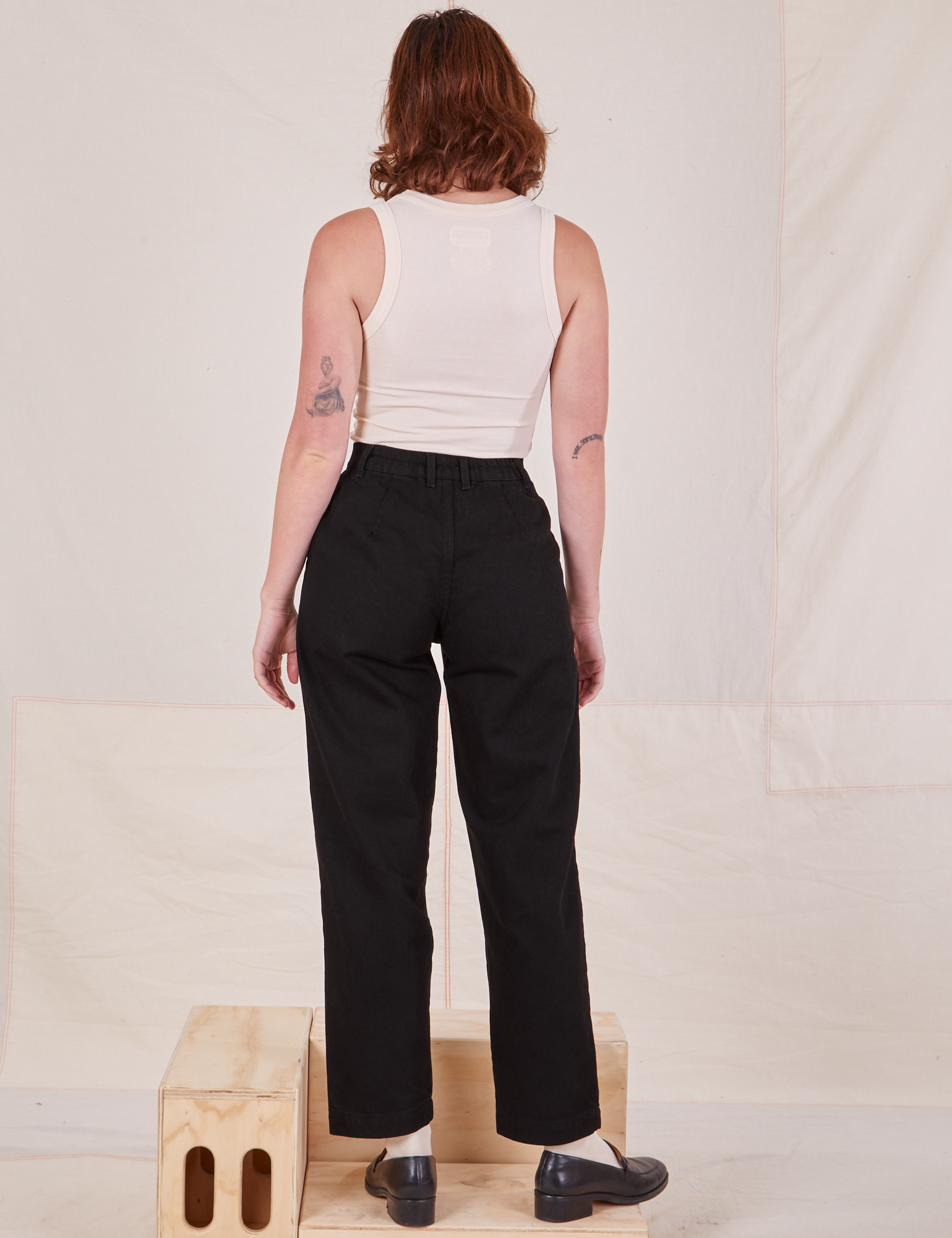 Back view of Denim Trouser Jeans in Black and Tank Top in vintage tee off-white worn by Alex