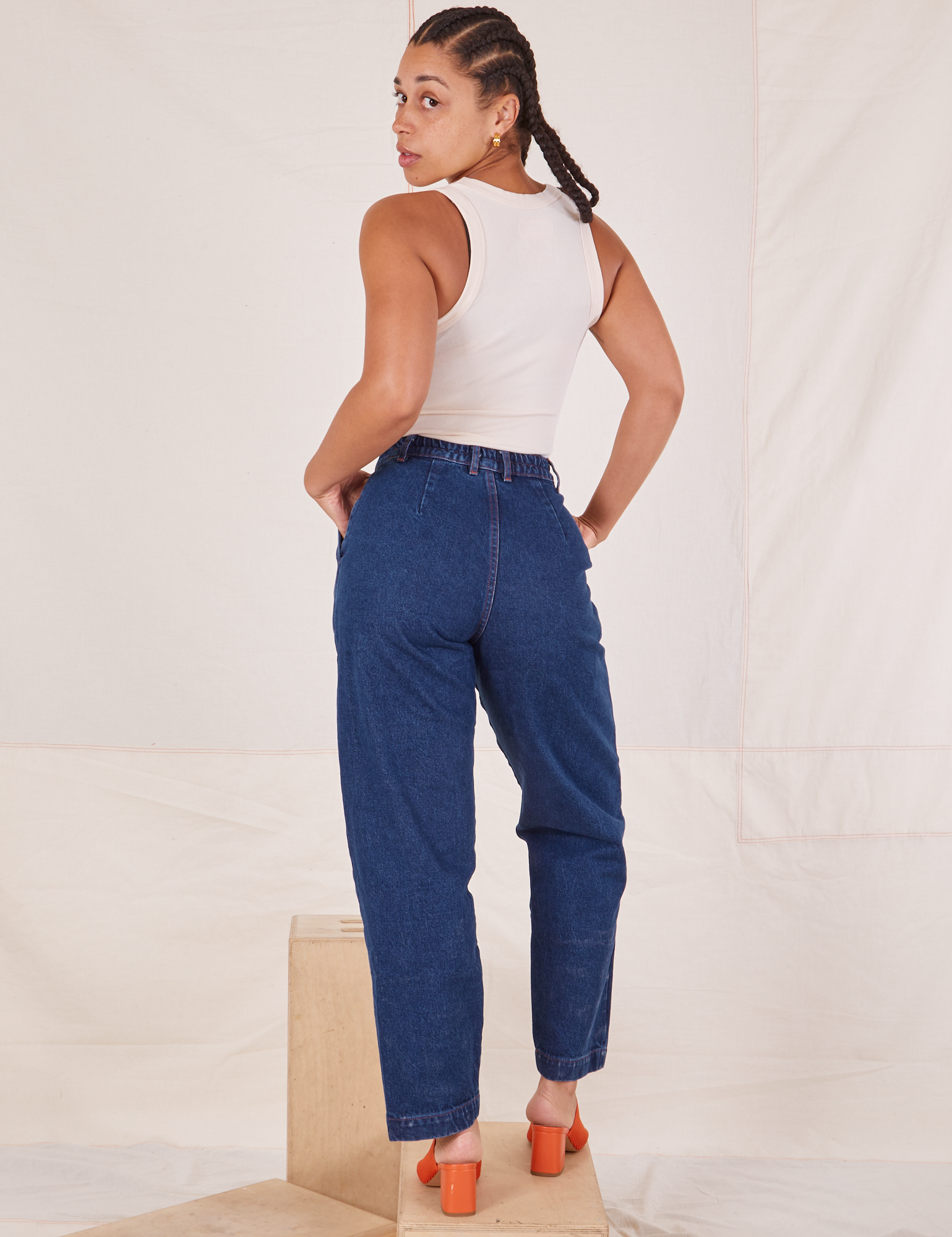 Back view of Denim Trouser Jeans in Dark Wash and Tank Top in vintage tee off-white worn by Gabi