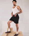 Angled front view of Trouser Shorts in Basic Black and Tank Top in vintage tee off-white on Jesse