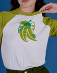 Front close up of Produce Raglan Tee in Snap Peas on Alex