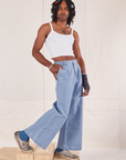 Jerrod is wearing Indigo Wide Leg Trousers in Light Wash and vintage off-white Cami