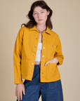 Alex is 5'8" and wearing P Denim Work Jacket in Mustard Yellow