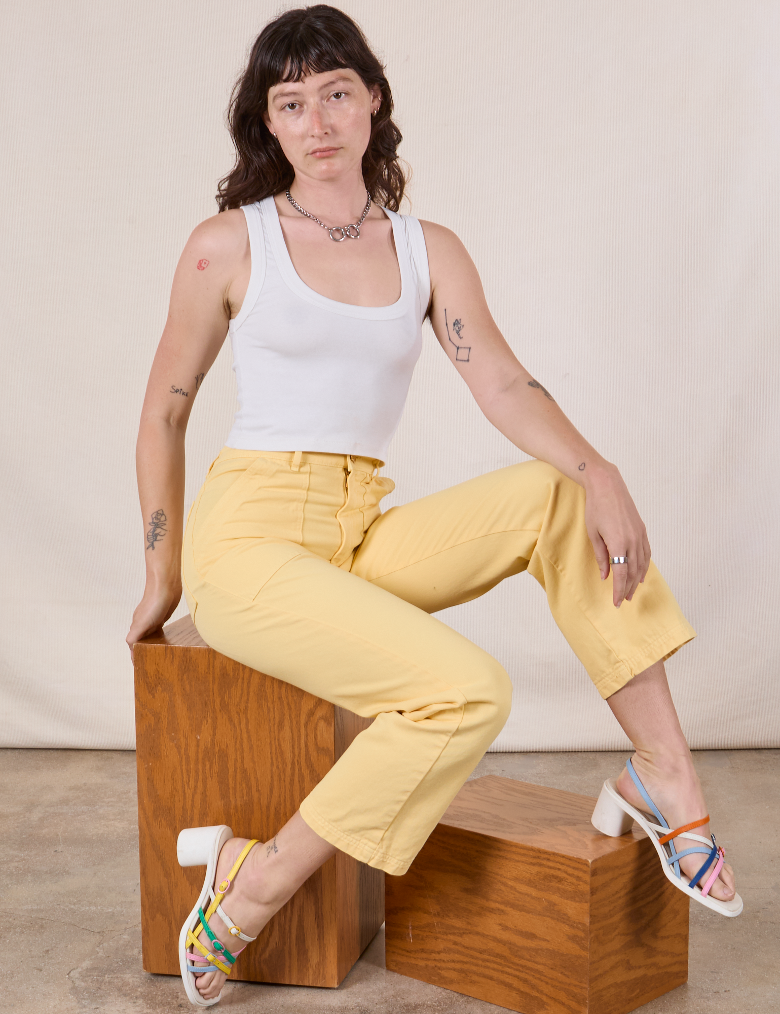 Alex is wearing Work Pants in Butter Yellow and Cropped Tank in vintage tee off-white