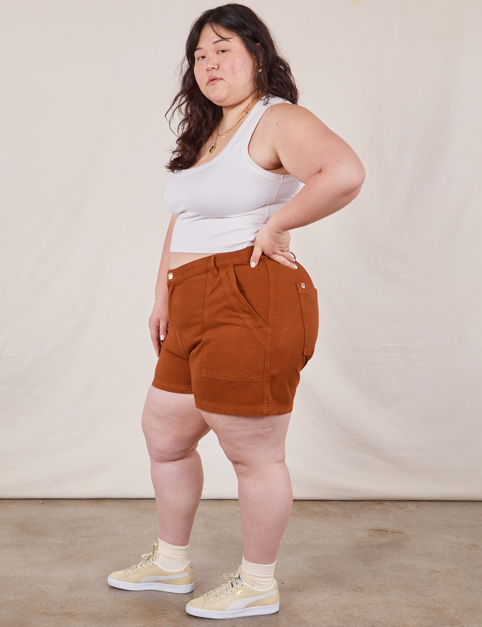 Side view of Classic Work Shorts in Burnt Terracotta and Cropped Tank Top in vintage tee off-white on Ashley