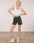 Madeline is 5’9” and wearing XXS Classic Work Shorts in Swamp Green paired with a Cropped Tank Top in vintage tee off-white