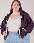 Marielena is 5'8" and wearing L Cropped Zip Hoodie in Nebula Purple paired with a vintage off-white Cropped Tank underneath
