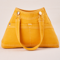 Overall Handbag in Mustard Yellow with handle strap down across front