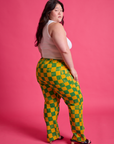 Angled back view of Checkerboard Work Pants in Green/Yellow and Cropped Tank in Vintage Tee White