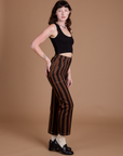 Side view of Black Stripe Work Pants in Fudgesicle Brown and black Cropped Tank on Alex
