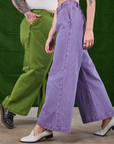 Sam is wearing Overdyed Wide Leg Trousers in Gross Green and Alex is wearing Overdyed Wide Leg Trousers in Faded Grape