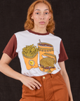Tiara is wearing Anniversary Tee in Fast Food tucked into burnt terracotta Work Pants