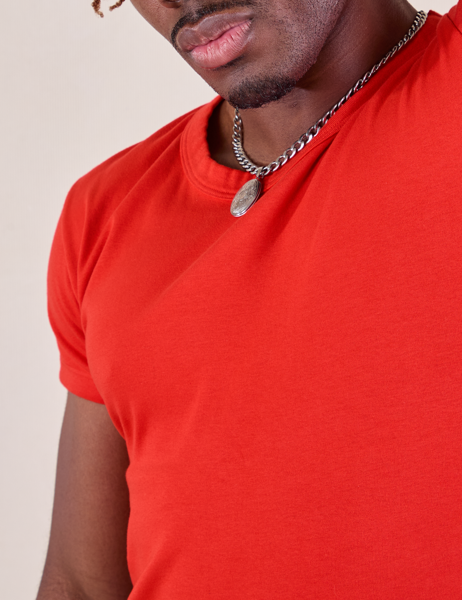 Baby Tee in Mustang Red front close up on Isaac