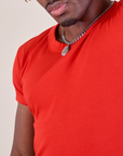 Baby Tee in Mustang Red front close up on Isaac