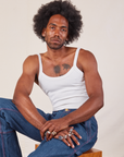 Jerrod is wearing Cropped Cami in Vintage Tee Off-White and dark wash Carpenter Jeans