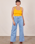 Tiara is wearing Cropped Cami in Sunshine Yellow and light wash Sailor Jeans