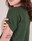 Cropped Burly Tee in Swamp Green shoulder close up on Alex