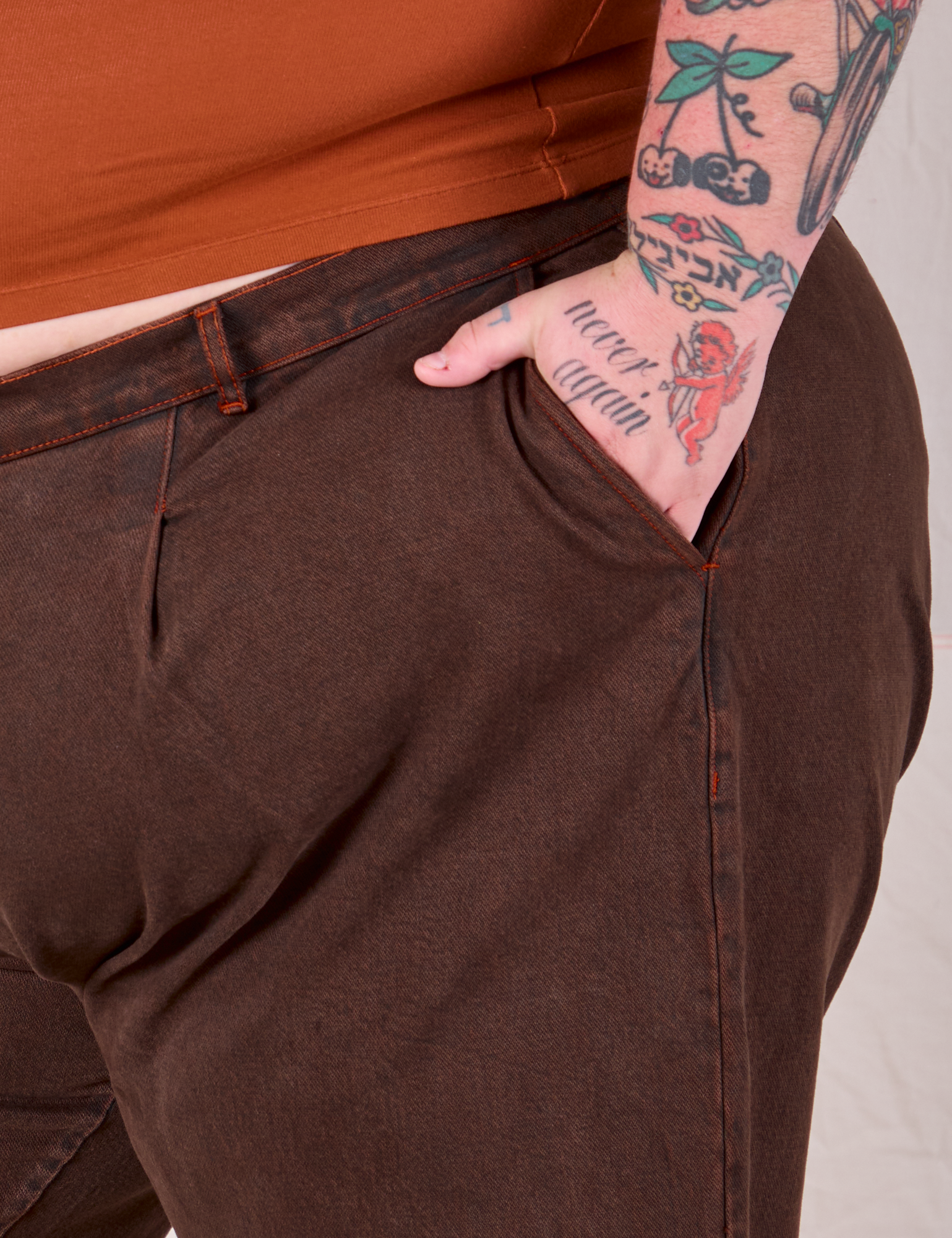 Overdyed Denim Trouser in Fudge front pocket close up with Sam's hand in the pocket