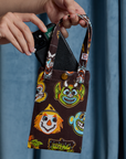 Halloween Masks Cell Phone Tote with Alex tucking in a phone