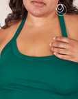 Front close up of Halter Top in Hunter Green worn by Alicia. Alicia has her hand on the halter strap.