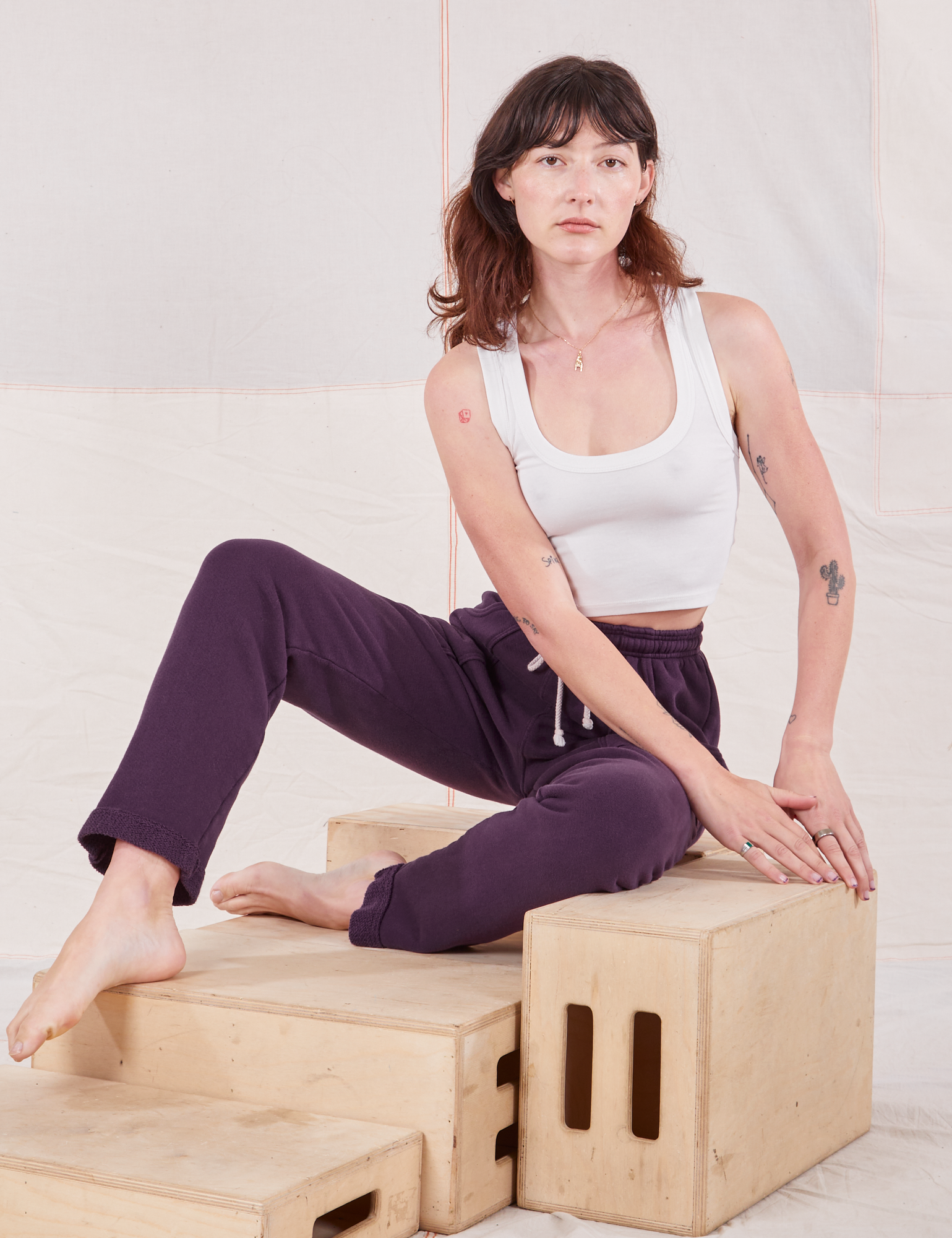 Alex is wearing Rolled Cuff Sweat Pants in Nebula Purple and Cropped Tank in vintage tee off-white