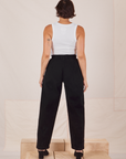 Back view of Heavyweight Trousers in Basic Black and Cropped Tank Top in vintage tee off-white worn by Tiara