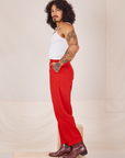 Side view of Heavyweight Trousers in Mustang Red and Cropped Cami in vintage tee off-white worn by Jesse