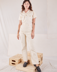 Alex is 5'8" and wearing XXS Heritage Short Sleeve Jumpsuit in Natural