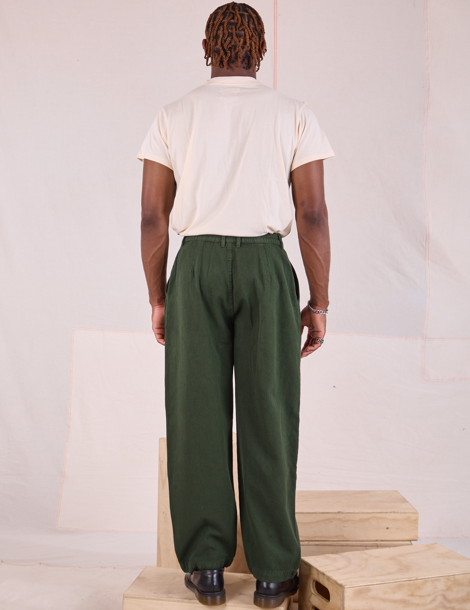 Back view of Heritage Trousers in Swamp Green and Organic Vintage Tee in vintage tee off-white on Issac
