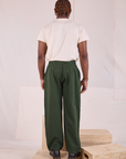Back view of Heritage Trousers in Swamp Green and Organic Vintage Tee in vintage tee off-white on Issac