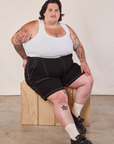 Sam is wearing Carpenter Shorts in Basic Black and Cropped Tank in vintage tee off-white