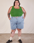 Sam is 5'10" and wearing 3XL Carpenter Shorts in Light Wash paired with a lawn green Cropped Tank