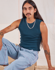 Anthony is wearing Muscle Tee in Lagoon and light wash Carpenter Jeans