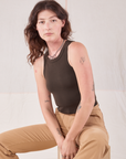 Alex is sitting and wearing Racerback Tank in Espresso Brown