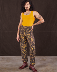Jesse is 5'8" and wearing XS Marble Splatter Work Pants in Espresso Brown paired with mustard yellow Tank Top
