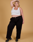 Juliet is 5'7" and wearing 1XL Baggy Mid-Rise Trousers in Basic Black paired with a vintage tee white Cropped Tank