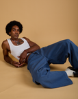 Jerrod is wearing Baggy Mid-Rise Trousers in French Blue and vintage tee white Cropped Tank