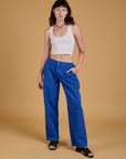 Alex is 5'8" and wearing XXS Baggy Mid-Rise Trousers in Royal Blue paired with a vintage tee white Cropped Tank