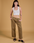Alex is 5'8" and wearing XXS Baggy Mid-Rise Trousers in Desert Brown paired with a vintage tee white Cropped Tank